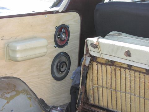 1979 Ford Bronco - Custom door panel with speakers and a worn seat are visible inside a vehicle.