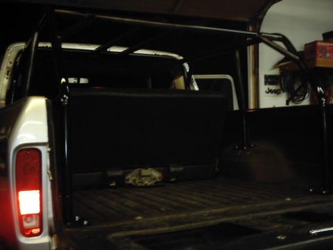 1978 Ford Bronco - This 1978 Ford Bronco features a prominent roll cage and a view into its black interior and cargo area.