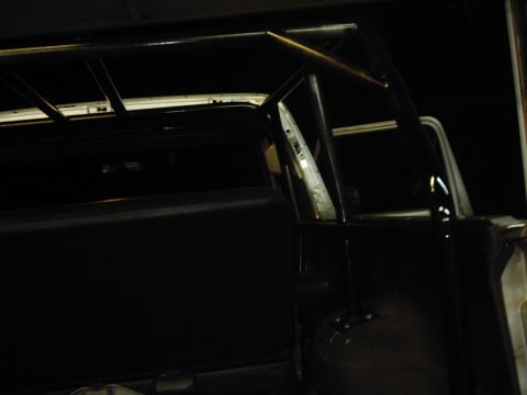 1978 Ford Bronco - A custom roll cage is visible inside a dark vehicle, obscuring most of the interior details.