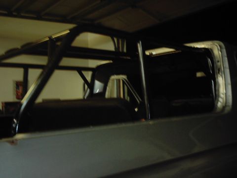 1978 Ford Bronco - A roll cage is visible inside a vehicle, obscuring much of the interior details.
