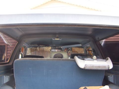 1986 Ford Bronco - Interior view of a 1986 Ford Bronco, showing the rear seating area and headliner.