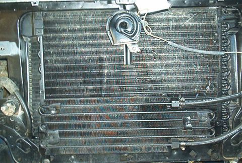 1986 Ford Bronco - Close-up of a vehicle's radiator and AC condenser, with a horn visible.