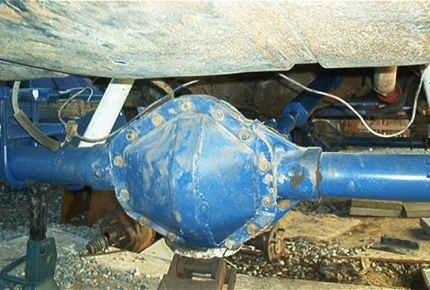 1986 Ford Bronco - Close-up view of a blue rear axle differential, likely from a truck or SUV, supported by jack stands.