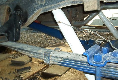 1986 Ford Bronco - Leaf springs and shock absorbers are visible in this close-up view of vehicle suspension components.