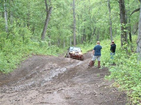 2000 Jeep TJ - Jeep TJ stuck in mud on a wooded trail with onlookers.