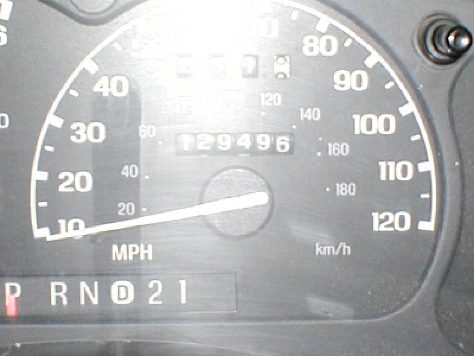 Speedometer shows 129,496 miles. Gear selector shows P R N D 2 1