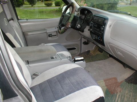 1979 Ford Bronco - The interior of a 1995 Ford Explorer, two-tone cloth seats and a camouflage steering wheel cover.