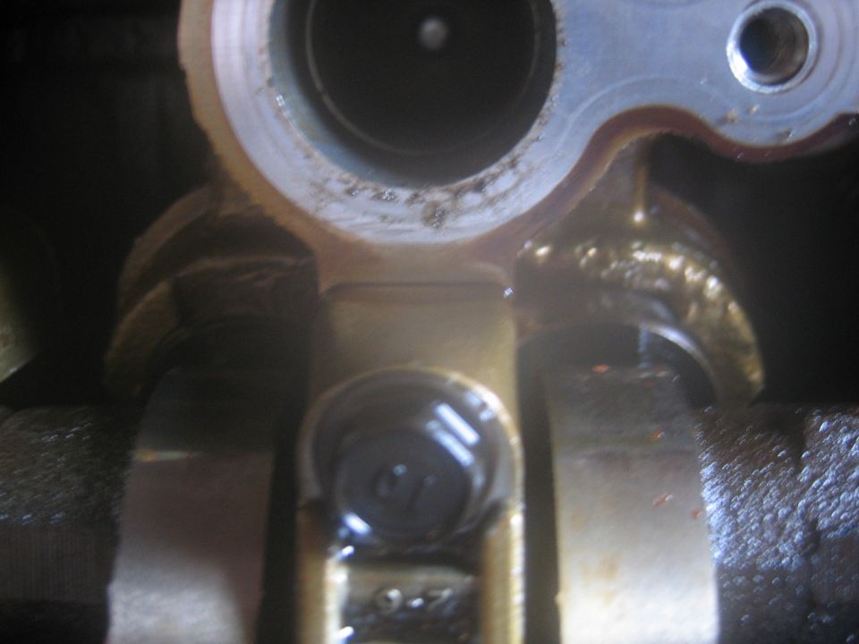 Close-up of engine component with visible bolt and markings