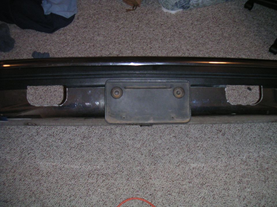 Rear bumper with license plate mount and cutouts for recovery points