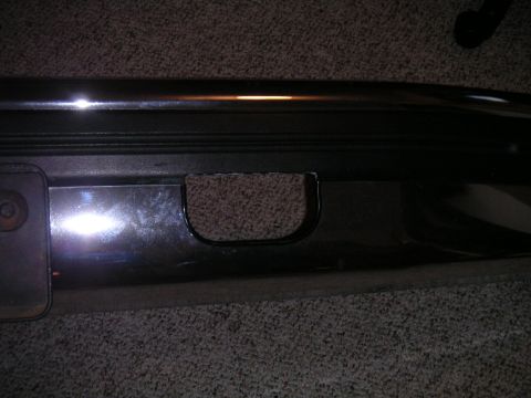 1994 Ford Bronco - Close-up of a chrome bumper, showing a tow hook access point.