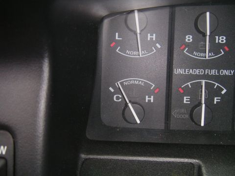 1994 Ford Bronco - Close-up of dashboard gauges, indicating fuel and temperature readings within the vehicle's interior.