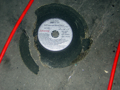 14-inch Chicago metal cut-off wheel on concrete floor with red rods nearby
