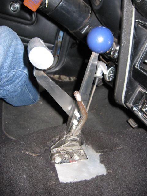 1972 Ford Mustang - Custom shifter assembly with a blue shift knob is visible in the interior of a vehicle, possibly modified, vehicle.
