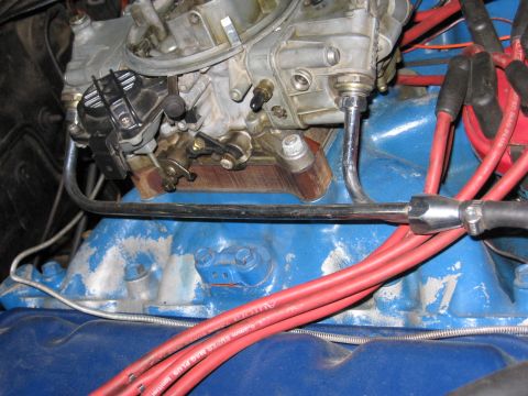 1972 Ford Mustang - Engine detail showing carburetor and spark plug wires on a blue intake manifold.