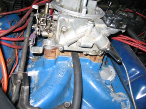 1972 Ford Mustang - Close-up view of an engine's carburetor and intake manifold with visible wiring.