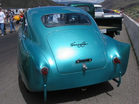 1972 Ford Mustang - Rear view of a custom teal coupe, possibly a Henry J, at an outdoor event.