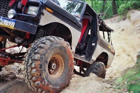 1978 Ford Bronco - This modified 1978 Ford Bronco navigates a challenging off-road course with its prominent, large tires.