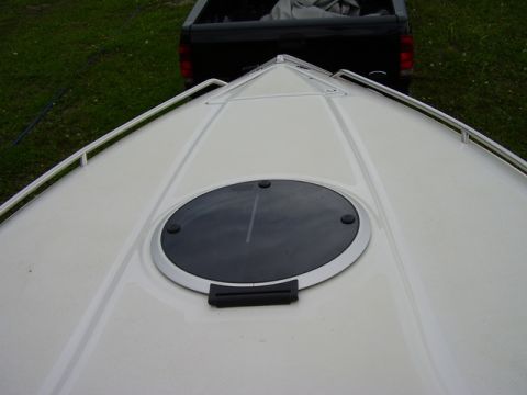 1997 Crownline 266 CCR - White boat deck with a circular hatch, black pickup truck visible in background.