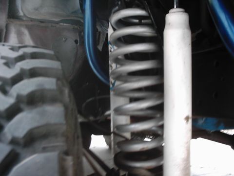 1978 Ford Bronco - A detailed view of off-road suspension components, including a tire and shock absorber.