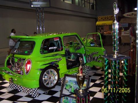 2005 Ford Focus - A highly customized lime green mini cooper is displayed with racing stripes, checkerboard accents, and trophies, dated 06/11/2005.