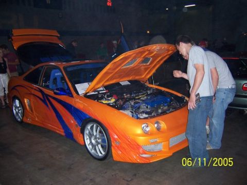 2005 Ford Focus - A modified orange sports car with custom graphics is displayed with its hood open.
