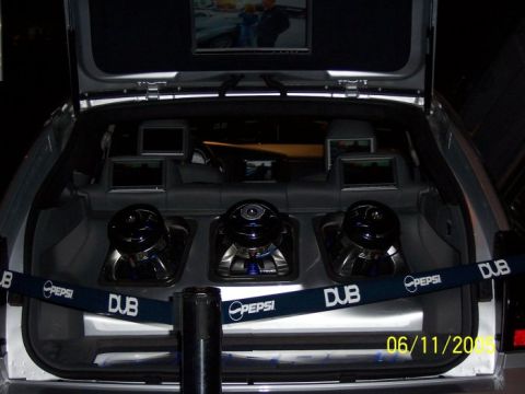 2005 Ford Focus - Custom car trunk setup subwoofers and video screens, with DUB and Pepsi branding visible.
