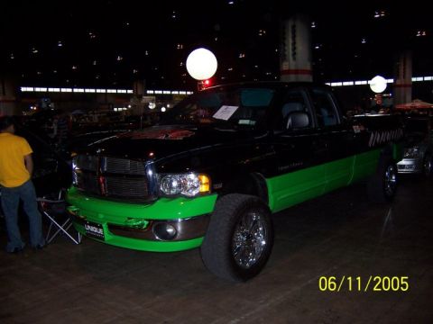 2005 Ford Focus - A customized Dodge Ram truck is displayed indoors, a two-tone paint scheme and prominent chrome wheels.
