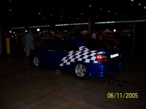 2005 Ford Focus - A blue Subaru WRX with checkered flag graphics is parked indoors, with the date 06/11/2005 visible in the lower right corner.