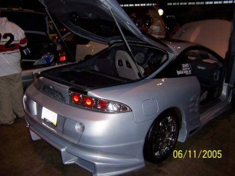 2005 Ford Focus - Silver sports coupe with custom body kit and open trunk, dated 06/11/2005.
