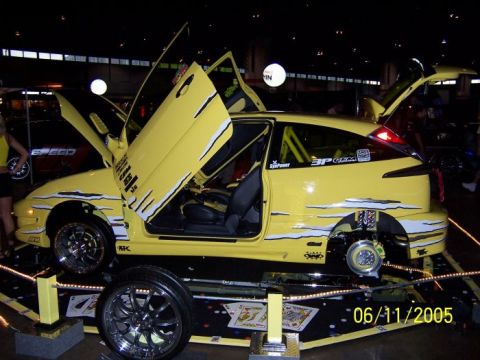 2005 Ford Focus - A modified yellow 2005 Ford Focus is displayed with its doors and trunk open.