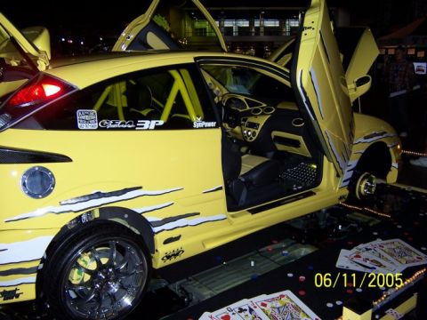 2005 Ford Focus - Customized 2005 Ford Focus displayed with doors open and racing stripes.