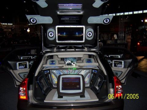 2005 Ford Focus - The rear of a car is customized with a large sound system, including multiple speakers and screens.