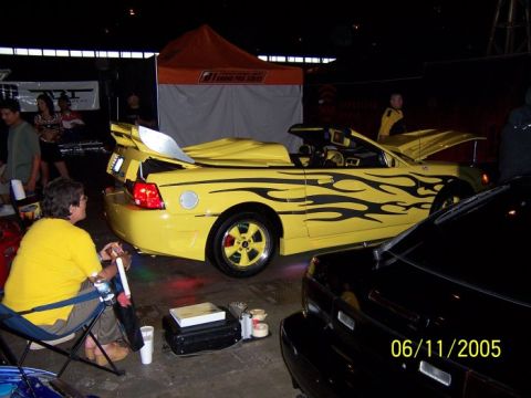 2005 Ford Focus - A yellow convertible with flame decals is shown, with a date stamp of 06/11/2005 visible.