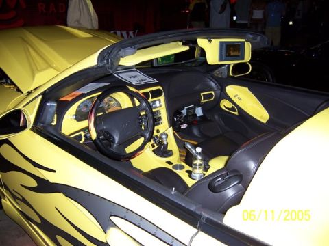 2005 Ford Focus - The interior of a yellow convertible is shown, custom flame graphics on the exterior and a date stamp indicating 06/11/2005.