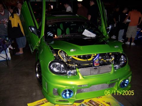 2005 Ford Focus - A modified car with its doors and hood open, displaying the engine and custom interior.