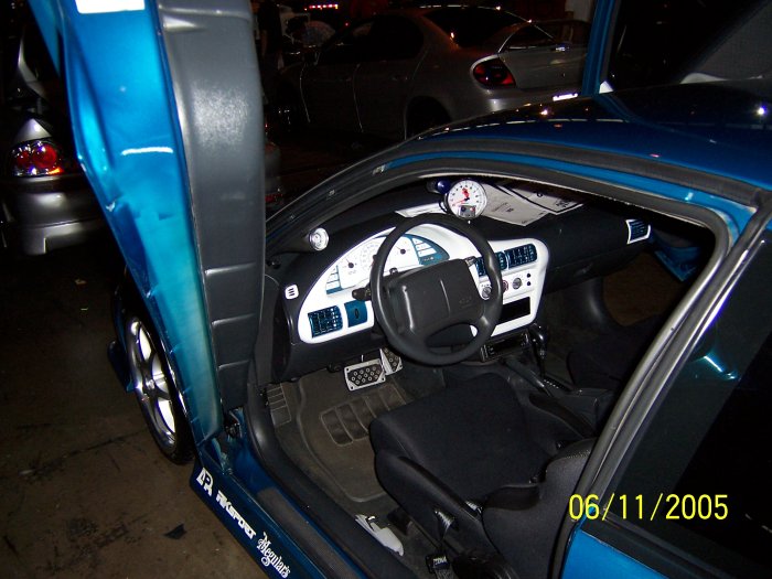 Blue car interior with custom gauges and suicide doors. Date stamp 06/11/2005