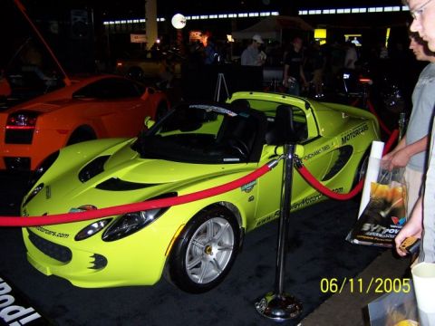 2005 Ford Focus - Lime green sports car on display, with an orange sports car in the background. The date is 06/11/2005.