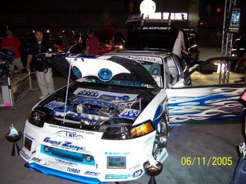 2005 Ford Focus - A heavily customized car with flame graphics and an exposed engine is displayed indoors, dated 06/11/2005.