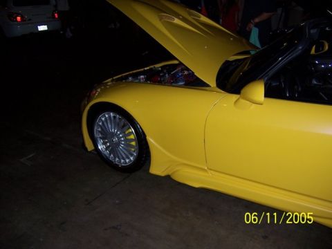 2005 Ford Focus - A yellow sports car is shown from the front quarter angle with its hood open, revealing the engine compartment.