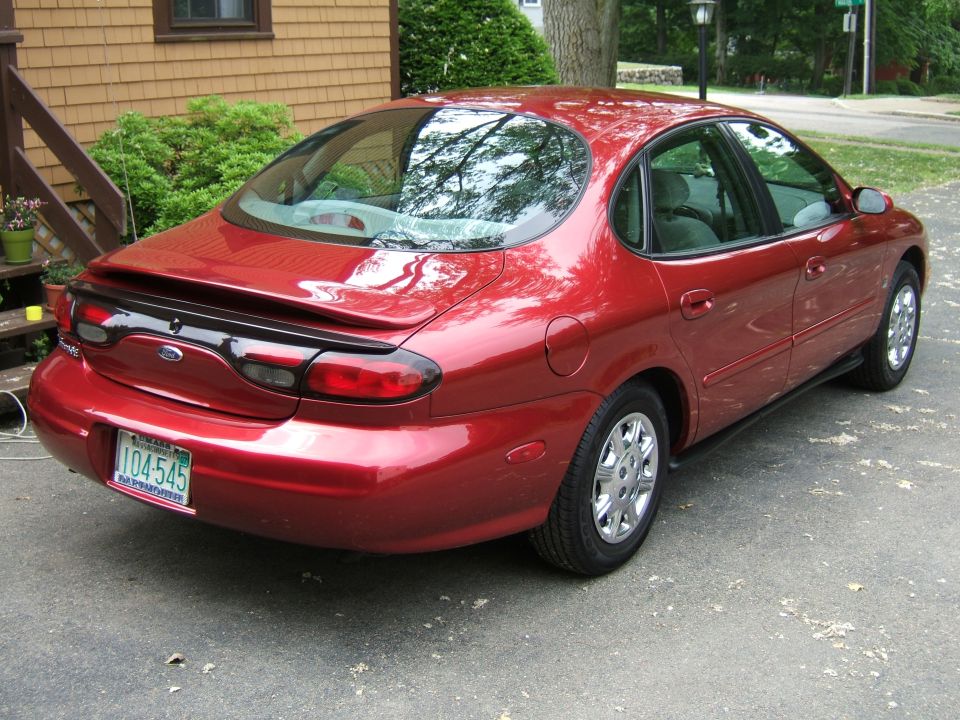 Red 1998 Ford Taurus sedan, rear view. License plate 104-545