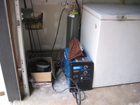 1991 Ford Explorer - Welding equipment setup next to a chest freezer in a garage.