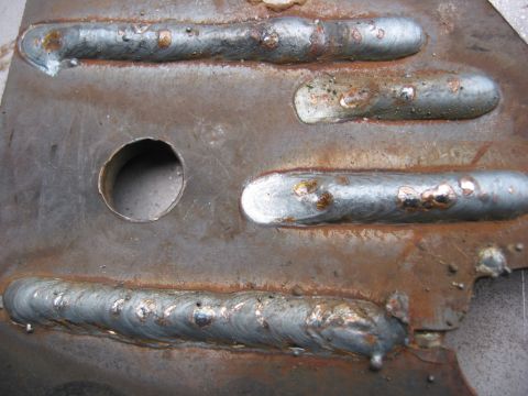 1991 Ford Explorer - This image shows a metal part with multiple welds and a hole, not a 1991 Ford Explorer.