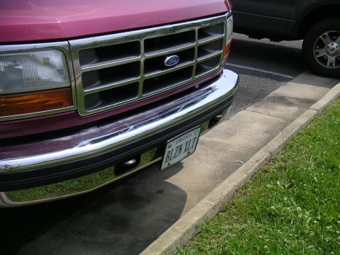 1994 Ford Bronco - Close-up of a Ford truck's front end, showing the grille and license plate.