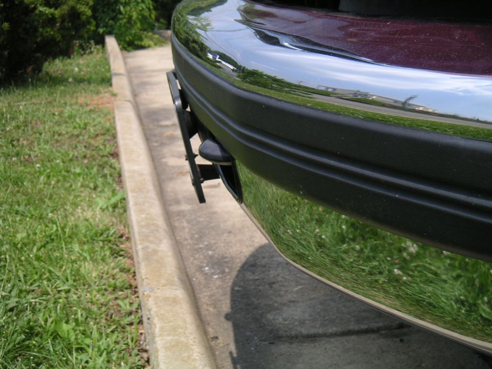 1994 Ford Bronco front bumper with chrome and black trim, showing license plate bracket