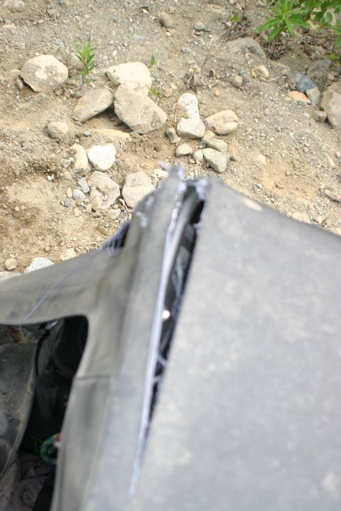 2003 Jeep TJ - A close-up view of a damaged soft top on a vehicle, revealing ripped seams and the interior.