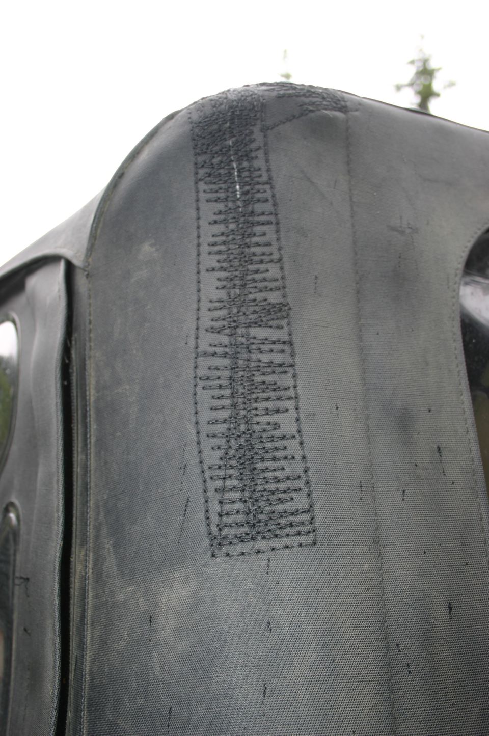Close-up of a dark gray soft top seam with visible stitching
