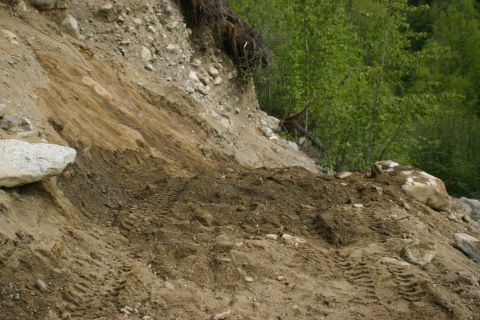 2003 Jeep TJ - Tire tracks mark the disturbed earth on a hillside, suggesting recent vehicle activity.