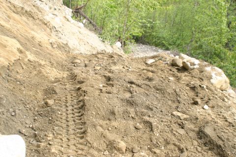 2003 Jeep TJ - Tire tracks are visible on a dirt slope, suggesting recent vehicle activity in the area.