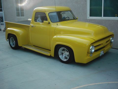 1978 Ford Bronco - A bright yellow 1953 Ford F-100 pickup truck is parked on a concrete surface.