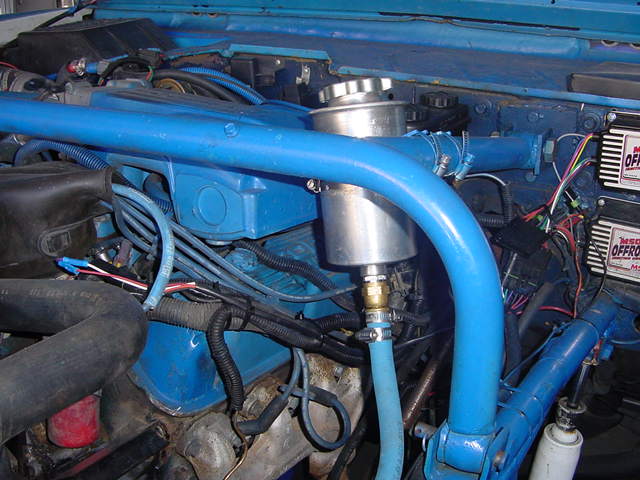 blue engine bay with blue roll cage, silver fluid reservoir, and MSD ignition boxes